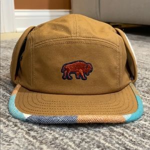 United by Blue bison ear-flap 5 panel hat.